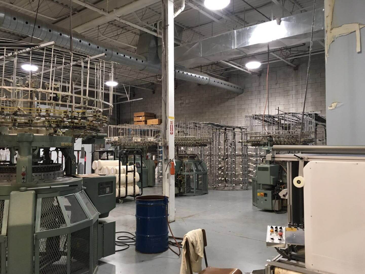 This Toronto factory renovation highlights a large-scale industrial interior upgrade designed to improve workflow, safety, and production efficiency. The project showcases an organized production floor with upgraded lighting, ventilation duct systems, and optimized machinery layout to support modern manufacturing operations. Completed by Reno Compass Inc., a trusted Toronto renovation company specializing in commercial and industrial projects, the renovation focuses on durable finishes, improved infrastructure, and a functional layout that enhances daily factory performance and long-term operational reliability.