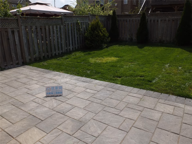 This image showcases a completed backyard interlock patio landscaping project in Markham. High-quality interlocking pavers were professionally installed to create a clean, durable outdoor patio area that integrates seamlessly with the lawn, enhancing both functionality and curb appeal for residential outdoor spaces.