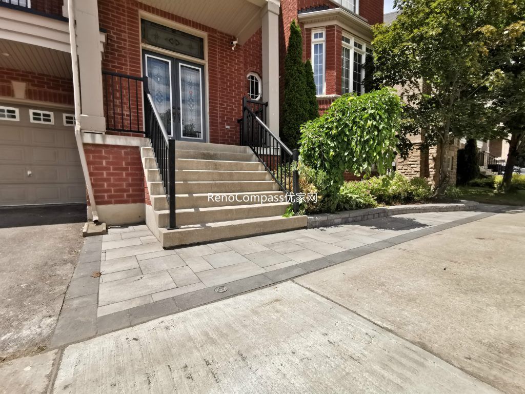 A refined front entrance interlocking project in Richmond Hill featuring elegant gray stone pavers and a clean edging design. This professional Reno Compass installation enhances the home's curb appeal and provides a durable, low-maintenance surface for everyday use.