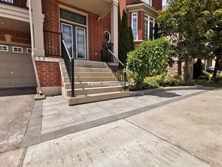 A refined front entrance interlocking project in Richmond Hill featuring elegant gray stone pavers and a clean edging design. This professional Reno Compass installation enhances the home's curb appeal and provides a durable, low-maintenance surface for everyday use.