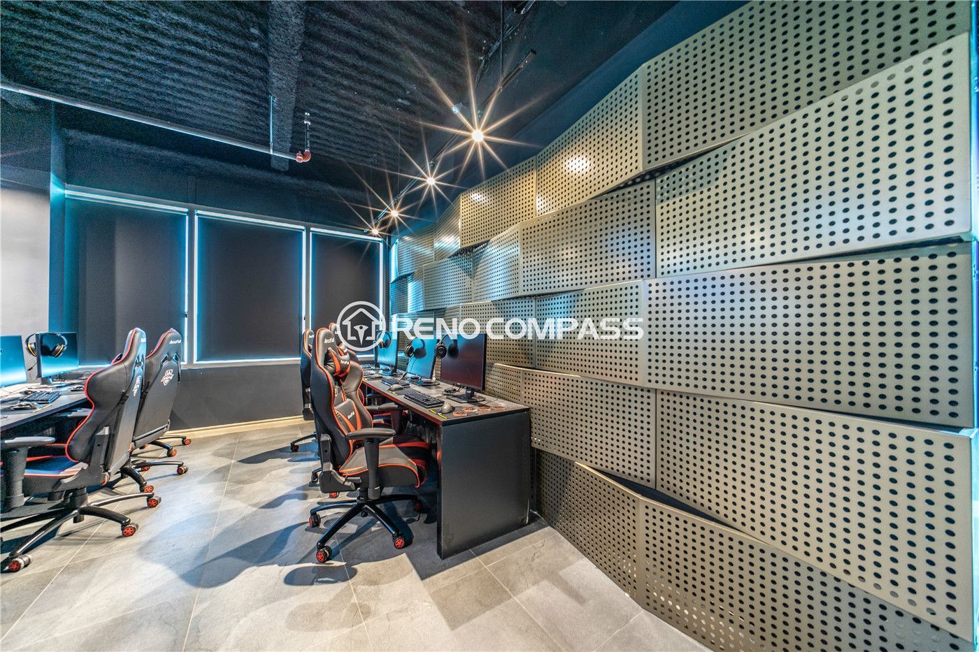 Professional internet cafe gaming room renovation in Markham featuring custom gaming desk installation, ergonomic gaming chairs, acoustic wall panels, and modern LED lighting design. This commercial gaming cafe construction project highlights organized wiring systems, durable tile flooring, and contemporary industrial ceiling finishes, creating an immersive and comfortable gaming environment by experienced Toronto renovation contractor Reno Compass Inc.