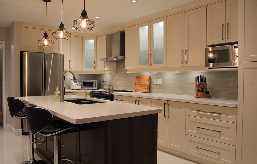 This Mississauga kitchen renovation features custom cream cabinetry, a large quartz island, modern pendant lighting, and upgraded backsplash design. Completed by a professional Toronto renovation company, the project focuses on improving functionality, storage, and modern aesthetics. The spacious island with built-in sink and seating enhances daily use and entertaining, while new lighting and finishes create a warm, elegant atmosphere. Ideal for homeowners in Mississauga seeking a stylish and practical kitchen upgrade with high-quality craftsmanship and thoughtful layout planning.