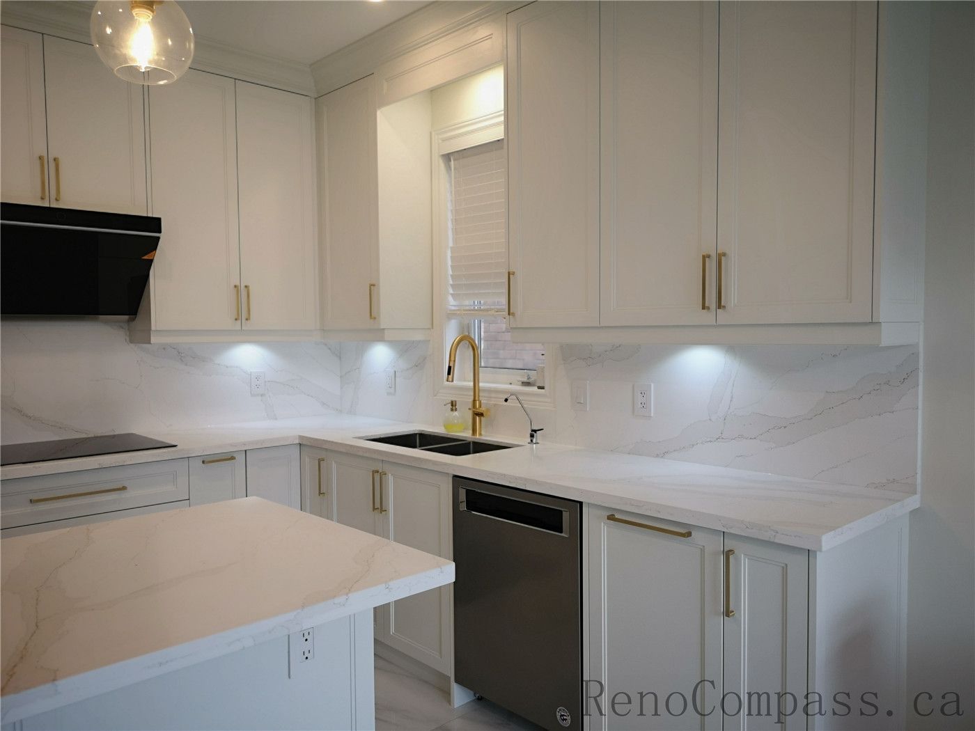 This Aurora kitchen renovation features a bright open-concept layout with custom white shaker cabinets, quartz countertops, and a spacious center island for everyday functionality. Elegant pendant lighting, marble-style flooring, and brushed gold hardware create a modern and luxurious atmosphere. Completed by a professional Toronto renovation company focused on high-quality craftsmanship, efficient layout design, and timeless interior finishes.