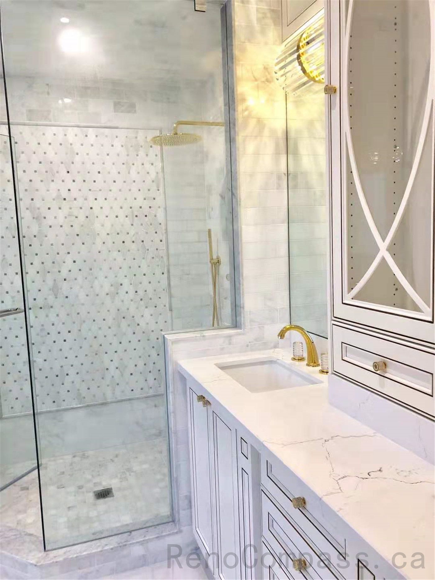 This North York bathroom renovation features a modern glass walk-in shower with marble-look wall tiles and mosaic accent details, paired with a custom vanity, quartz countertop, and elegant gold fixtures. The bright and refined layout enhances both functionality and luxury, creating a timeless and comfortable bathroom space. Completed by a professional Toronto renovation company specializing in high-end residential renovations.
