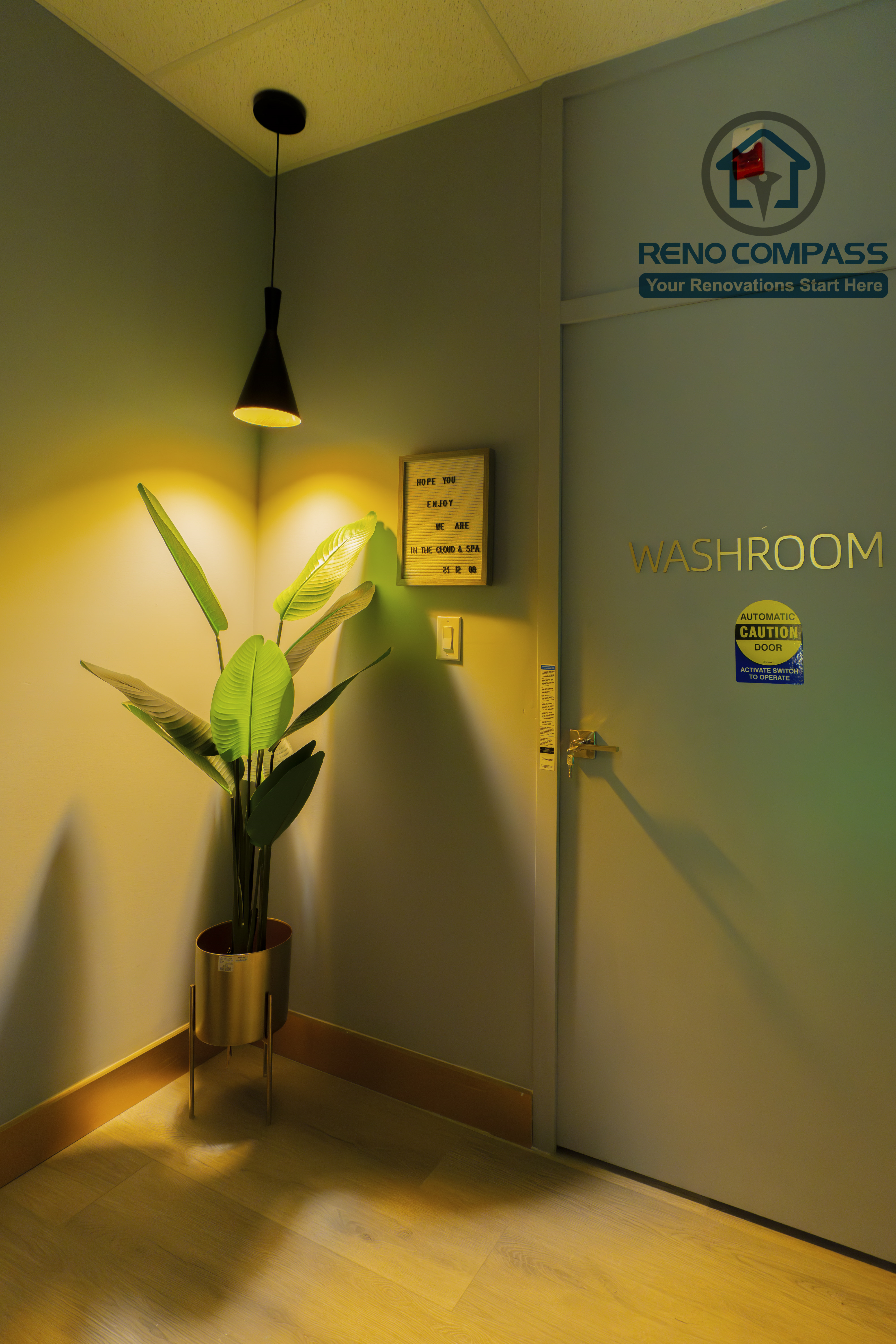 Washroom entrance and corridor completed as part of a North York beauty salon renovation. This area features warm pendant lighting, soft wall finishes, and accent greenery to create a calm transition between service spaces. Designed for clear circulation, visual comfort, and commercial functionality by a professional Toronto renovation company.
