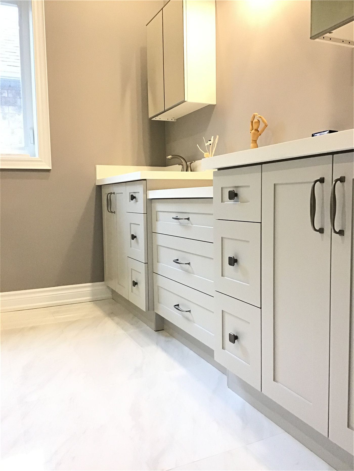 This Richmond Hill interior renovation highlights a modern bathroom vanity with custom cabinetry, soft neutral tones, and functional drawer storage. The clean design features durable finishes, sleek black handles, and a practical layout that maximizes organization and daily usability. Completed by a professional Toronto renovation company, this space reflects attention to detail, craftsmanship, and long-lasting quality.