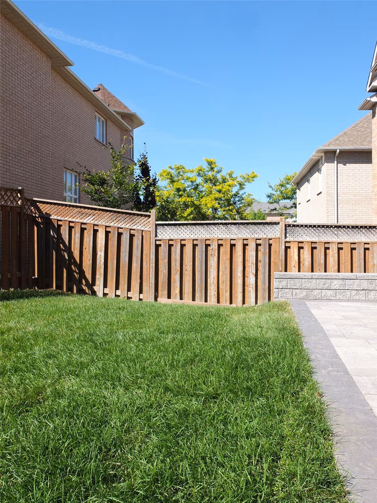 This Richmond Hill backyard landscaping renovation showcases a newly installed interlocking patio with clean stone steps and a raised retaining wall, creating a defined outdoor living space. The fresh green lawn and upgraded fencing enhance privacy and usability, making the backyard ideal for family gatherings and summer relaxation. Completed by a professional Toronto renovation company serving Richmond Hill and the GTA.