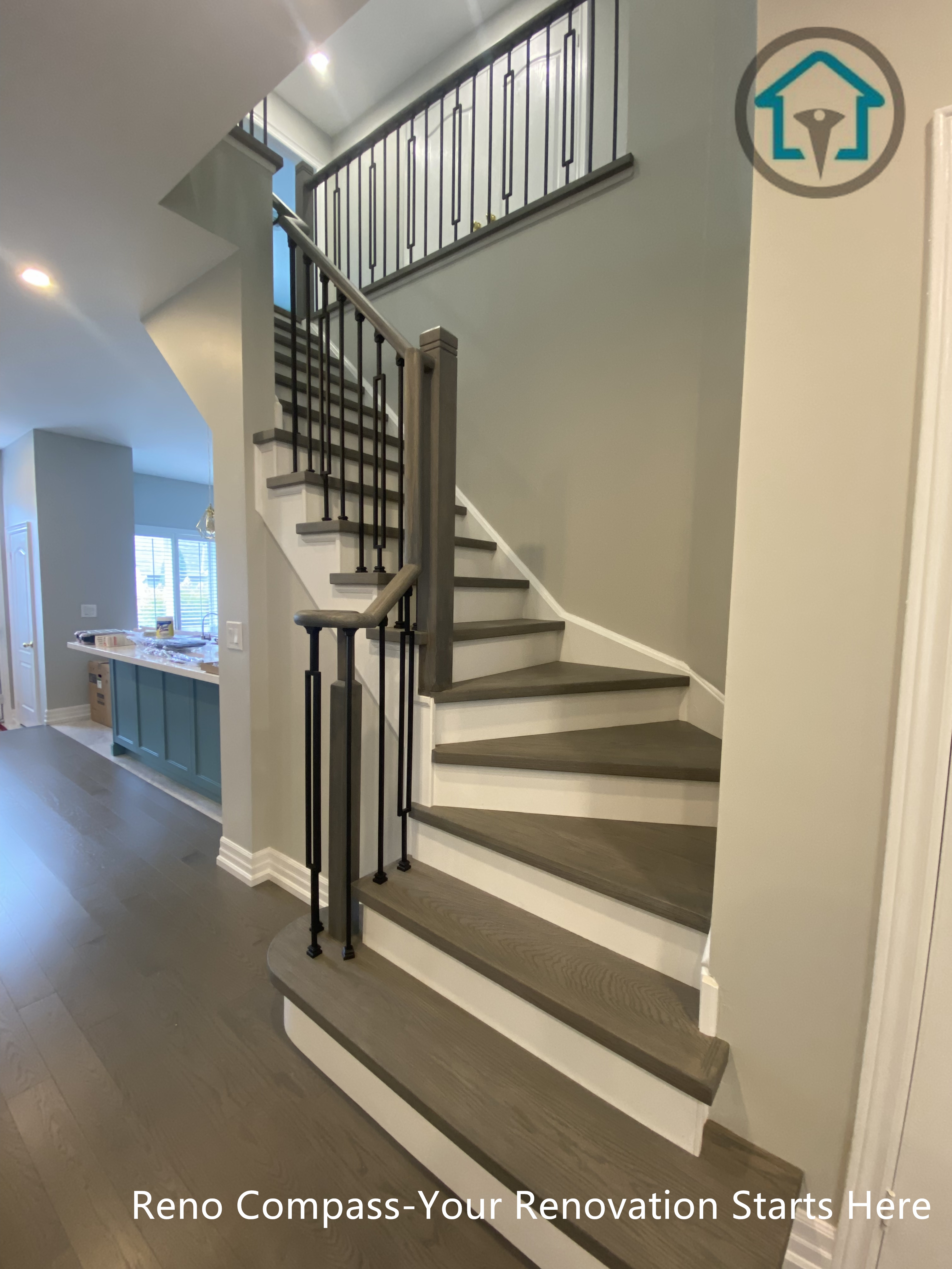 This modern staircase renovation features warm wood treads, clean white risers, and sleek black metal railings, creating a strong visual rhythm between structure and flow. The design emphasizes safety, proportion, and continuity across floors while keeping the space open and light. Thoughtful detailing and balanced materials allow the staircase to integrate naturally into the home’s overall interior renovation.