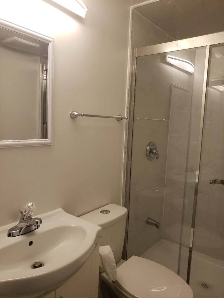 This Markham basement bathroom renovation features a modern glass-enclosed shower with clean tile finishes and updated plumbing fixtures. The space is designed for practicality and durability, incorporating a clear sliding glass door, neutral wall tiles, and efficient lighting to enhance brightness in the basement environment. Compact layout planning ensures comfortable use while maintaining a clean and contemporary look. This professionally completed basement bathroom highlights quality workmanship and thoughtful design, making it a functional addition to a fully finished basement in Markham.