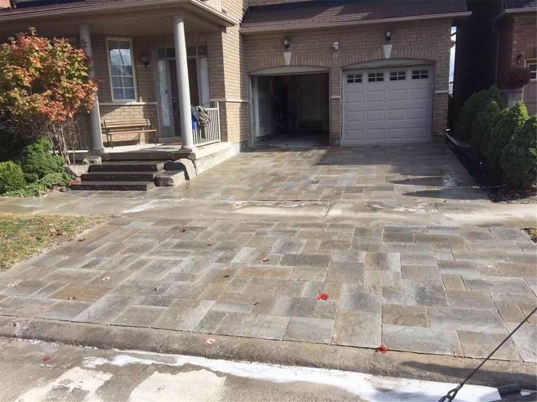 This Markham landscaping renovation features a beautifully installed interlocking stone driveway and front entrance walkway designed to enhance curb appeal and durability. The project includes precision-laid paving stones with natural color variation, creating a refined and elegant entrance to the home. Completed by a professional Toronto Renovation Company, the upgrade improves both functionality and the overall aesthetic of the property’s exterior.
