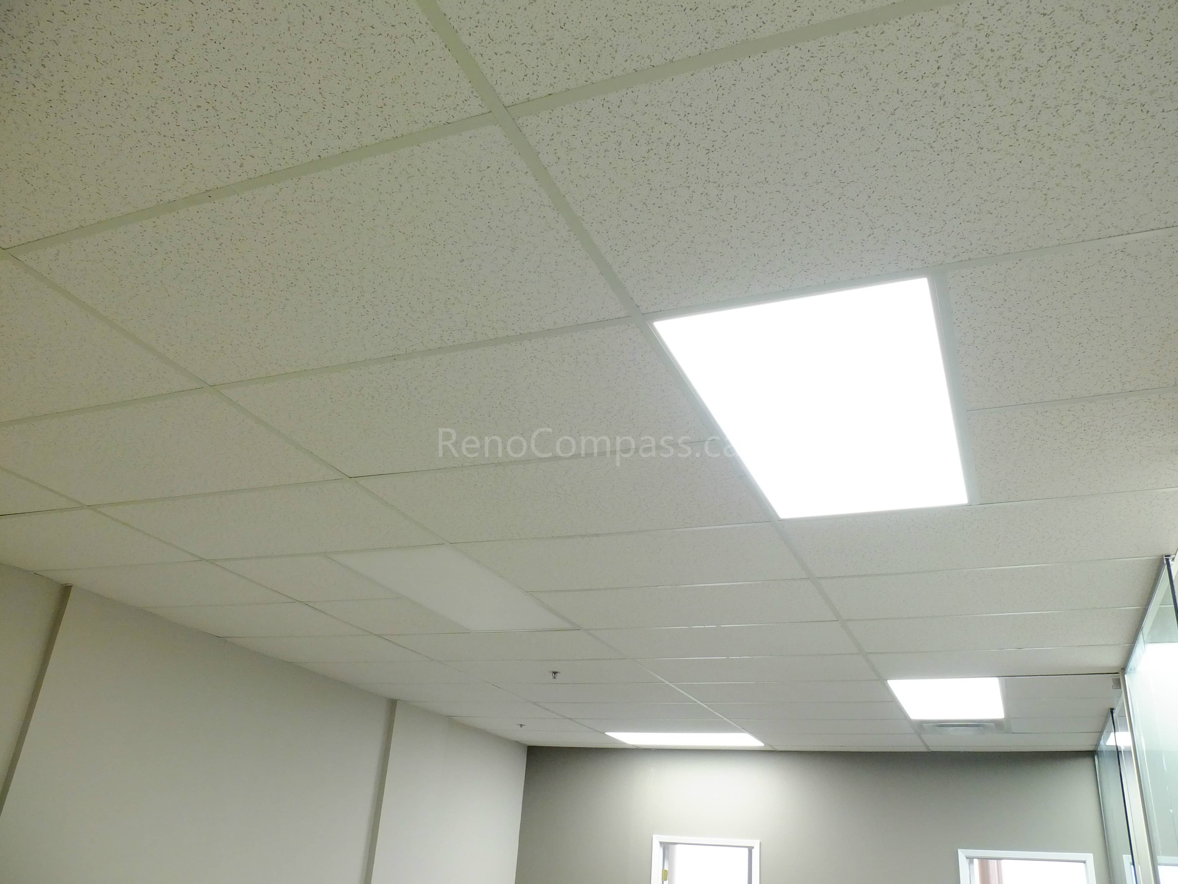 This photo shows a newly renovated office ceiling in North York, featuring modern suspended ceiling tiles and bright energy-efficient LED panel lights. The clean design enhances workspace illumination and creates a professional office environment.