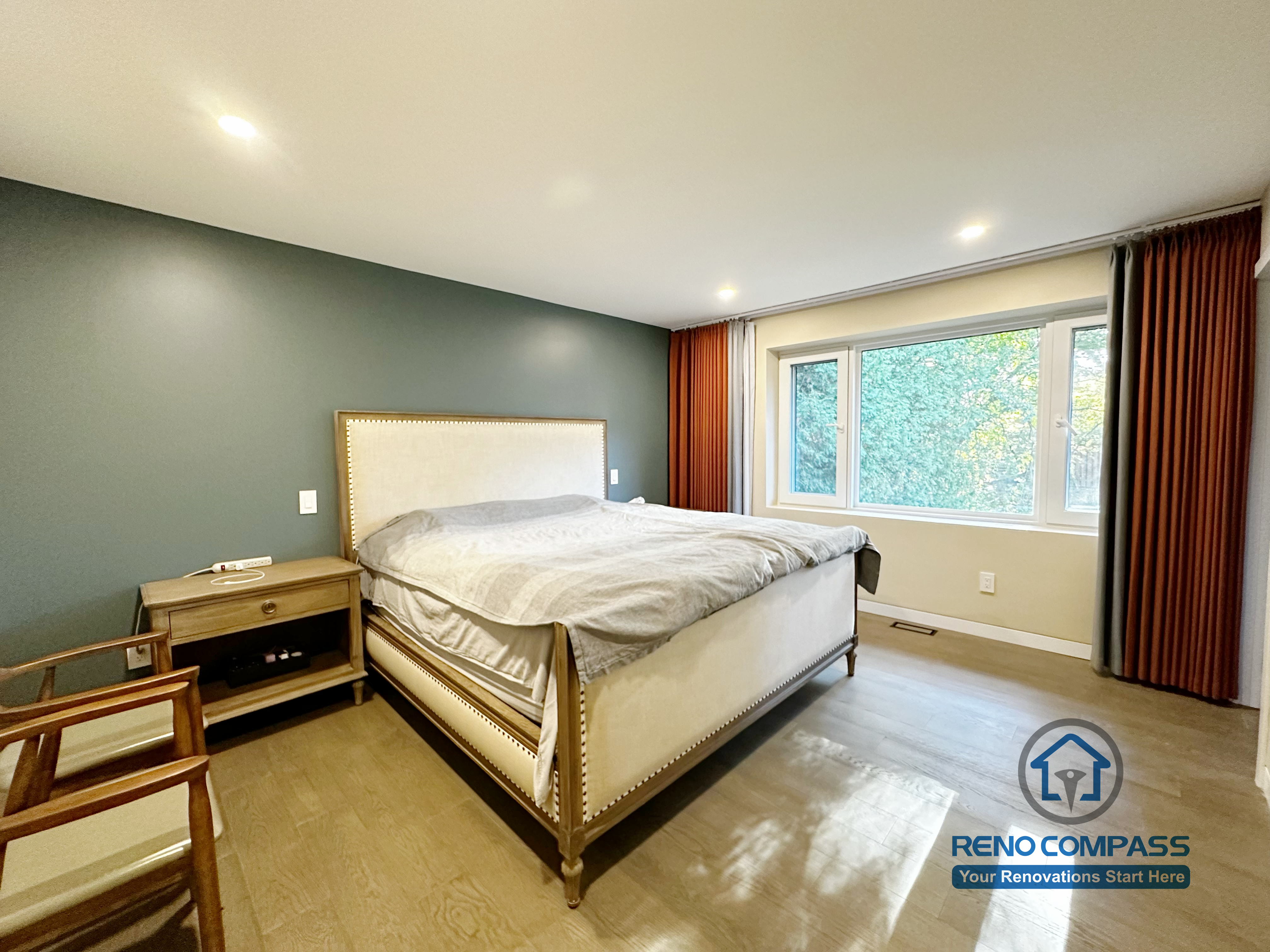 Modern bedroom completed as part of a North York interior renovation. This space features wide-plank flooring, recessed ceiling lighting, a calm neutral color palette, and large windows that enhance natural light. Designed for comfort, balance, and long-term livability by a professional Toronto renovation company.