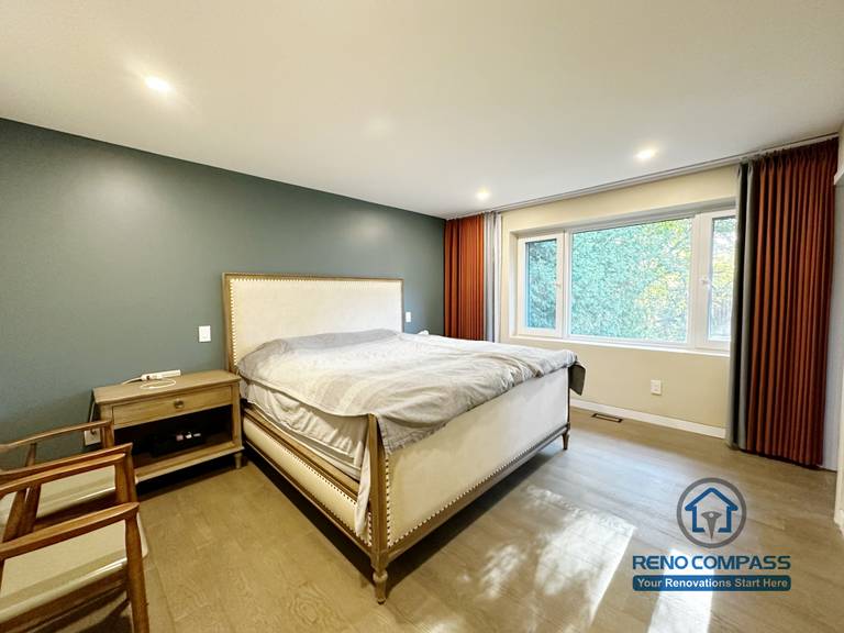 Modern bedroom completed as part of a North York interior renovation. This space features wide-plank flooring, recessed ceiling lighting, a calm neutral color palette, and large windows that enhance natural light. Designed for comfort, balance, and long-term livability by a professional Toronto renovation company.