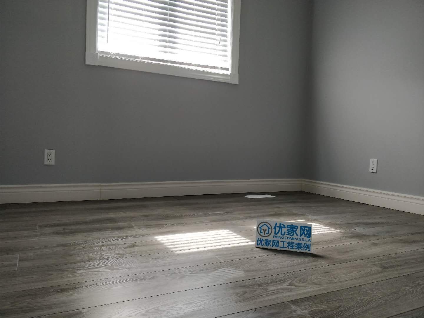 Bedroom interior renovation in Ajax featuring durable grey vinyl plank flooring, freshly painted walls, and updated white interior doors and baseboards. The modern flooring upgrade enhances the room’s brightness and functionality, completed by a professional Toronto renovation company specializing in residential interior improvements.
