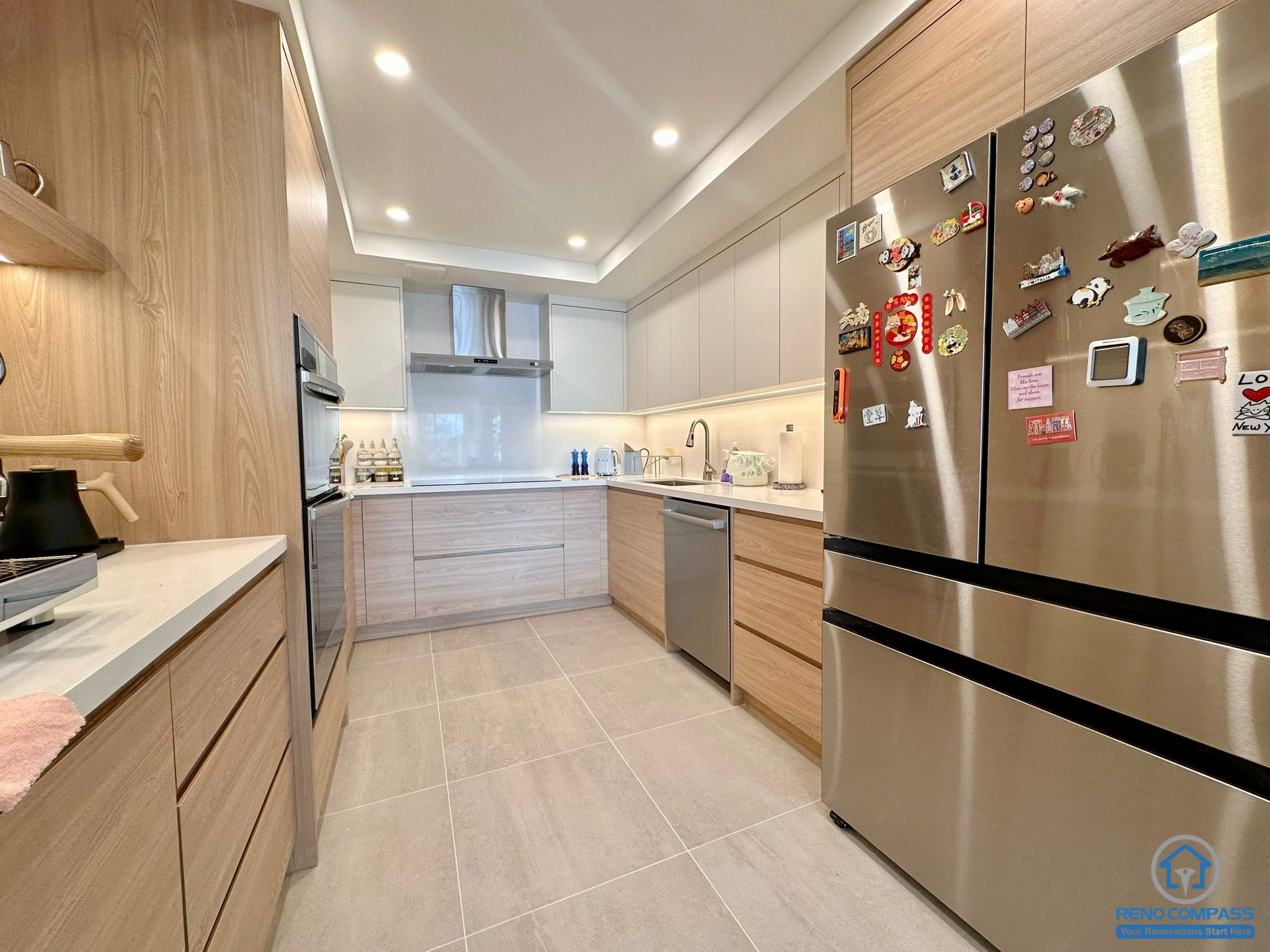 A fully renovated modern kitchen in Toronto featuring custom wood cabinetry, integrated appliances, recessed lighting, and a clean contemporary layout. The new design maximizes storage, workflow, and modern aesthetics for everyday living.