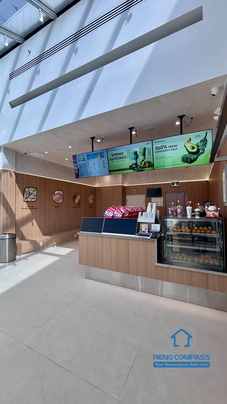 Completed TEABYDO bubble tea shop renovation in Richmond Hill featuring a bright skylight café interior, custom front service counter, beverage display fridge, digital menu boards, wood-tone commercial finishes, and clean minimalist customer-focused layout. Commercial renovation project completed by Reno Compass serving Richmond Hill, Toronto, and the GTA.