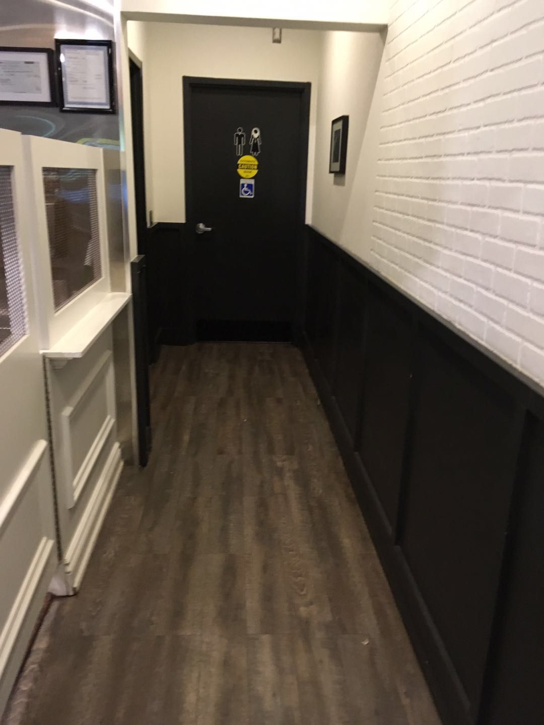 This Toronto spa renovation features a well-designed hallway leading to a commercial washroom, with durable flooring, decorative wall panels, and a clean, organized layout. The space ensures smooth customer flow while maintaining a modern and professional interior.