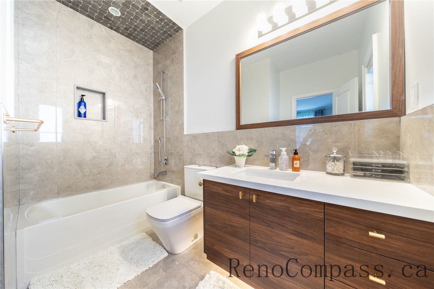 This Richmond Hill bathroom renovation features a modern bathtub and shower combination, custom wood vanity with quartz countertop, and elegant tile finishes throughout. The clean layout and upgraded fixtures enhance comfort and functionality, showcasing the quality craftsmanship of a trusted Toronto renovation company specializing in full house interior renovations.