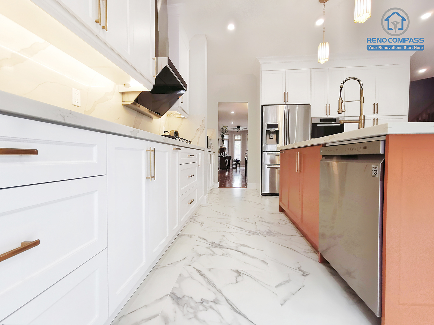 This Markham interior renovation captures the kitchen from a low-angle perspective, emphasizing circulation flow, spatial proportion, and material continuity. The walkway between the main cabinetry and the central island is finished with large-format marble-look porcelain flooring, enhancing durability and ease of maintenance in high-traffic areas. Custom white shaker cabinetry lines one side, while the island with integrated appliances anchors the opposite elevation. Clean sightlines and balanced spacing improve daily usability and create a sense of openness. Completed by Reno Compass, this kitchen renovation reflects careful planning of movement, storage, and long-term functionality tailored for modern Markham homes.