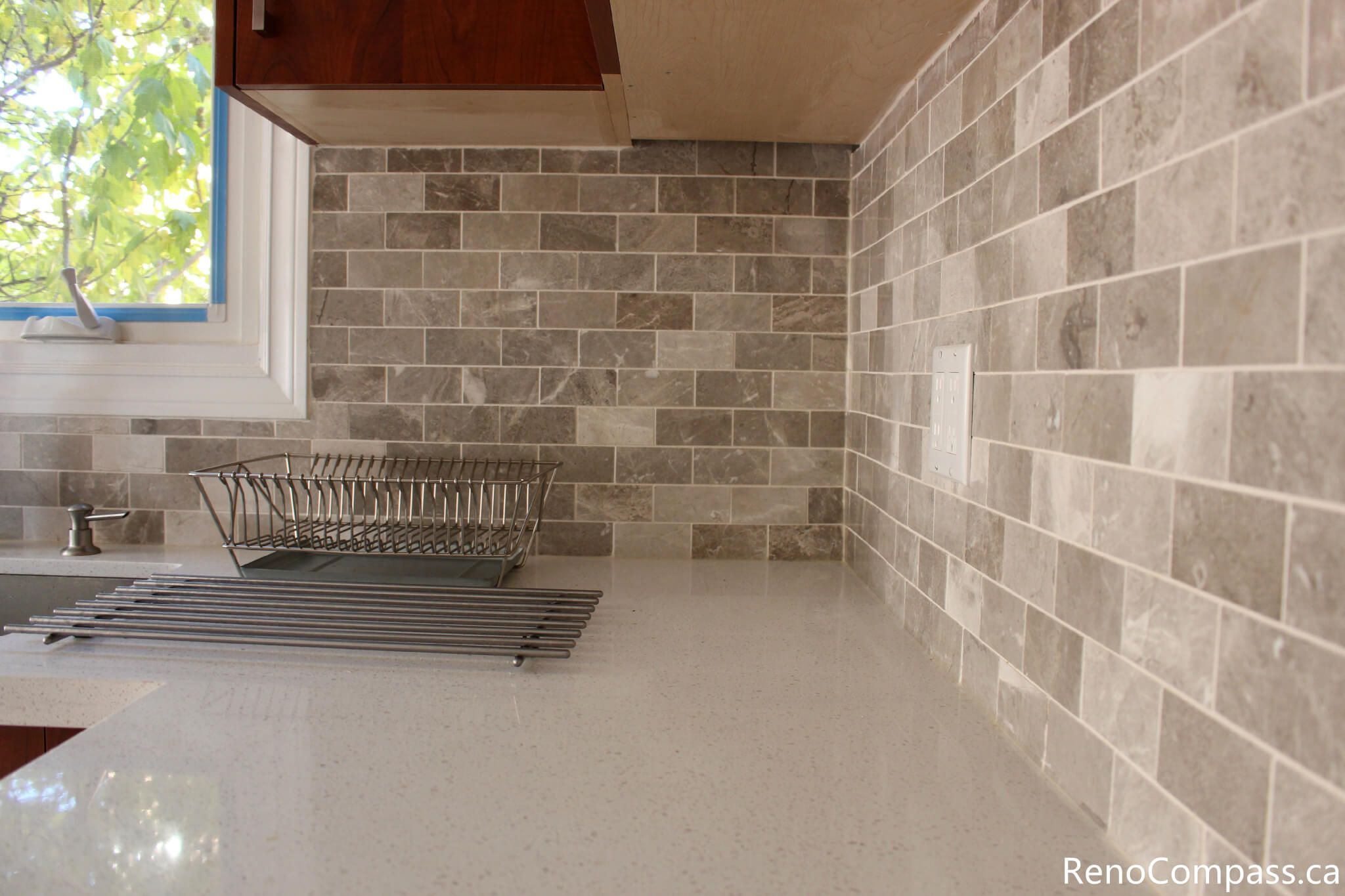 This detailed kitchen view highlights the quartz countertop and neutral mosaic tile backsplash installed during a full house renovation in Mississauga. The upgraded materials provide durability, easy maintenance, and a clean modern aesthetic that complements the custom cabinetry. Completed by a professional Toronto renovation company, this kitchen renovation enhances both visual appeal and everyday functionality while creating a bright and timeless cooking space.