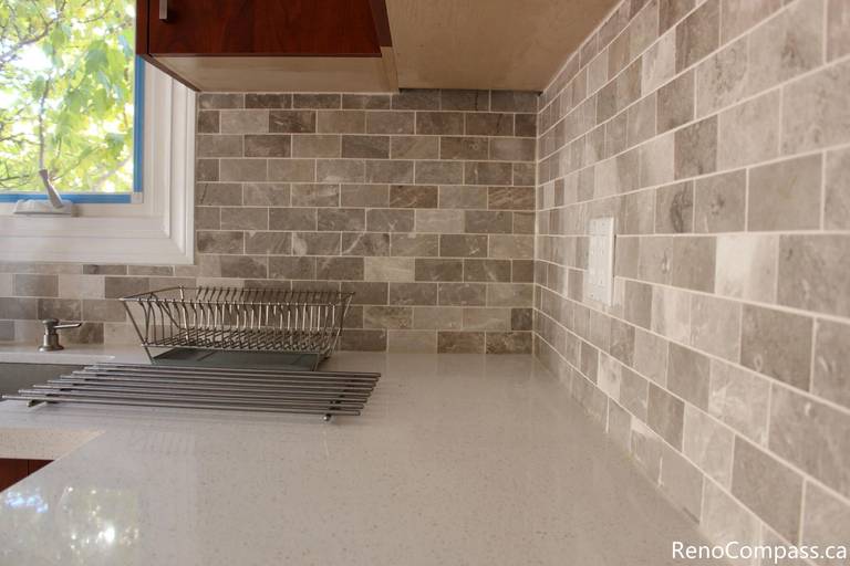 This detailed kitchen view highlights the quartz countertop and neutral mosaic tile backsplash installed during a full house renovation in Mississauga. The upgraded materials provide durability, easy maintenance, and a clean modern aesthetic that complements the custom cabinetry. Completed by a professional Toronto renovation company, this kitchen renovation enhances both visual appeal and everyday functionality while creating a bright and timeless cooking space.