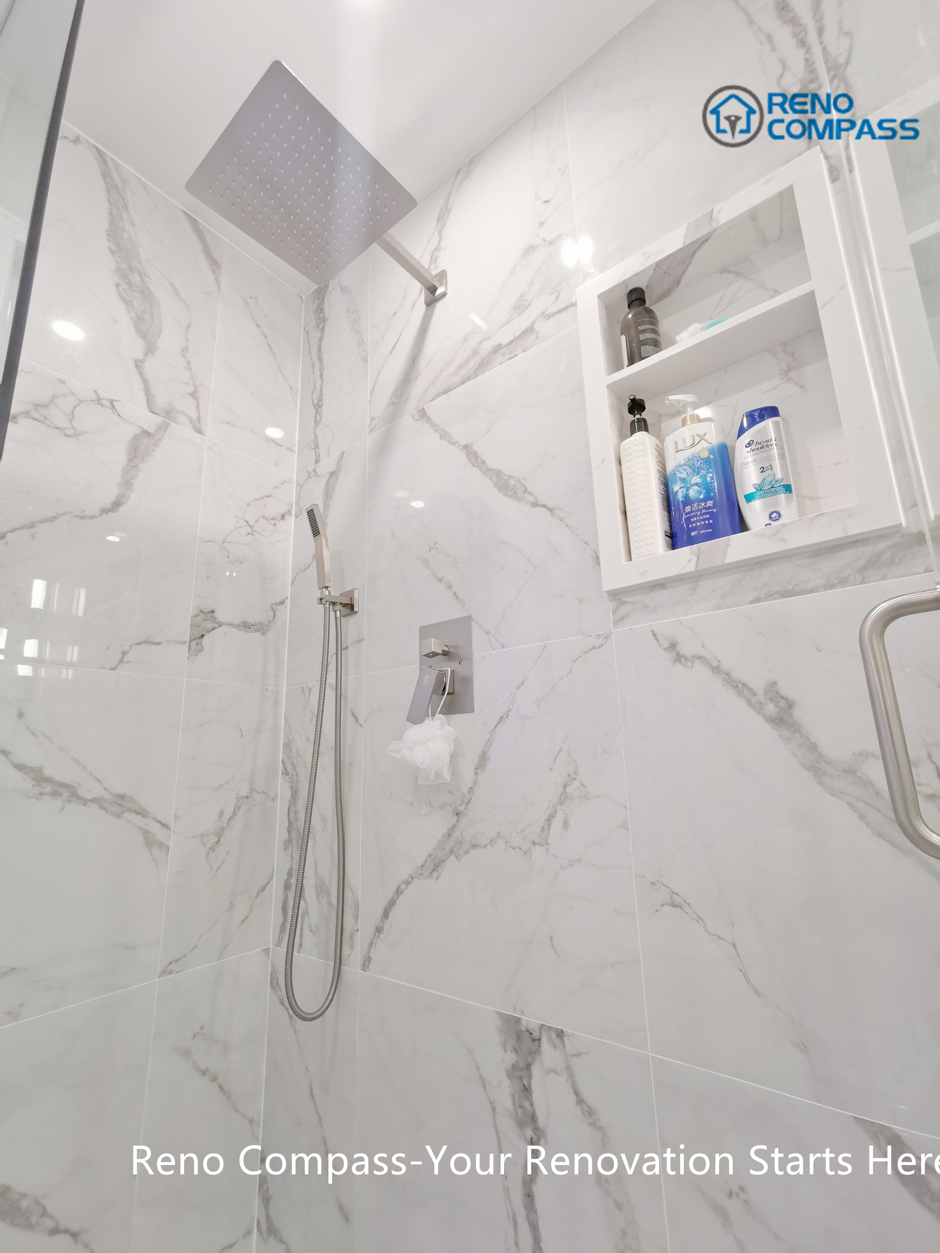 This Mississauga bathroom renovation highlights a frameless walk-in shower finished with large-format marble-look porcelain tiles. A ceiling-mounted rain shower head, handheld fixture, and built-in wall niche improve everyday comfort while maintaining a clean, minimalist appearance. The recessed storage niche enhances functionality without interrupting the visual flow of the space. Precision tile installation and thoughtful detailing reflect the quality standards expected from a professional Toronto renovation company.