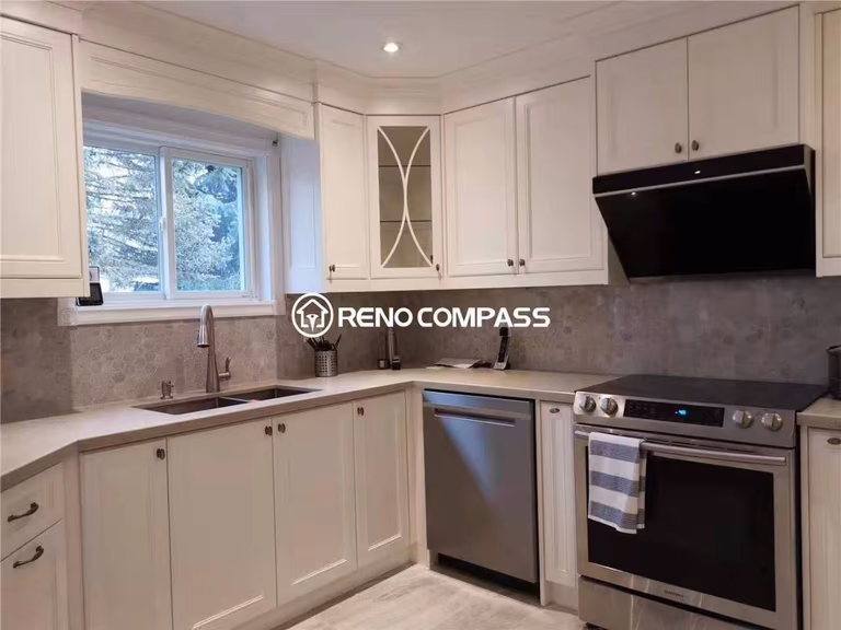 This kitchen renovation in Markham features custom white cabinetry, upgraded countertops, and modern stainless steel appliances to create a bright and functional cooking space. The L-shaped layout maximizes workflow and storage while enhancing natural light through the window area. Completed by a professional Toronto renovation company, the project focuses on practical design, durable materials, and a timeless neutral color palette, making it ideal for homeowners seeking a clean and efficient kitchen upgrade in the Markham area.
