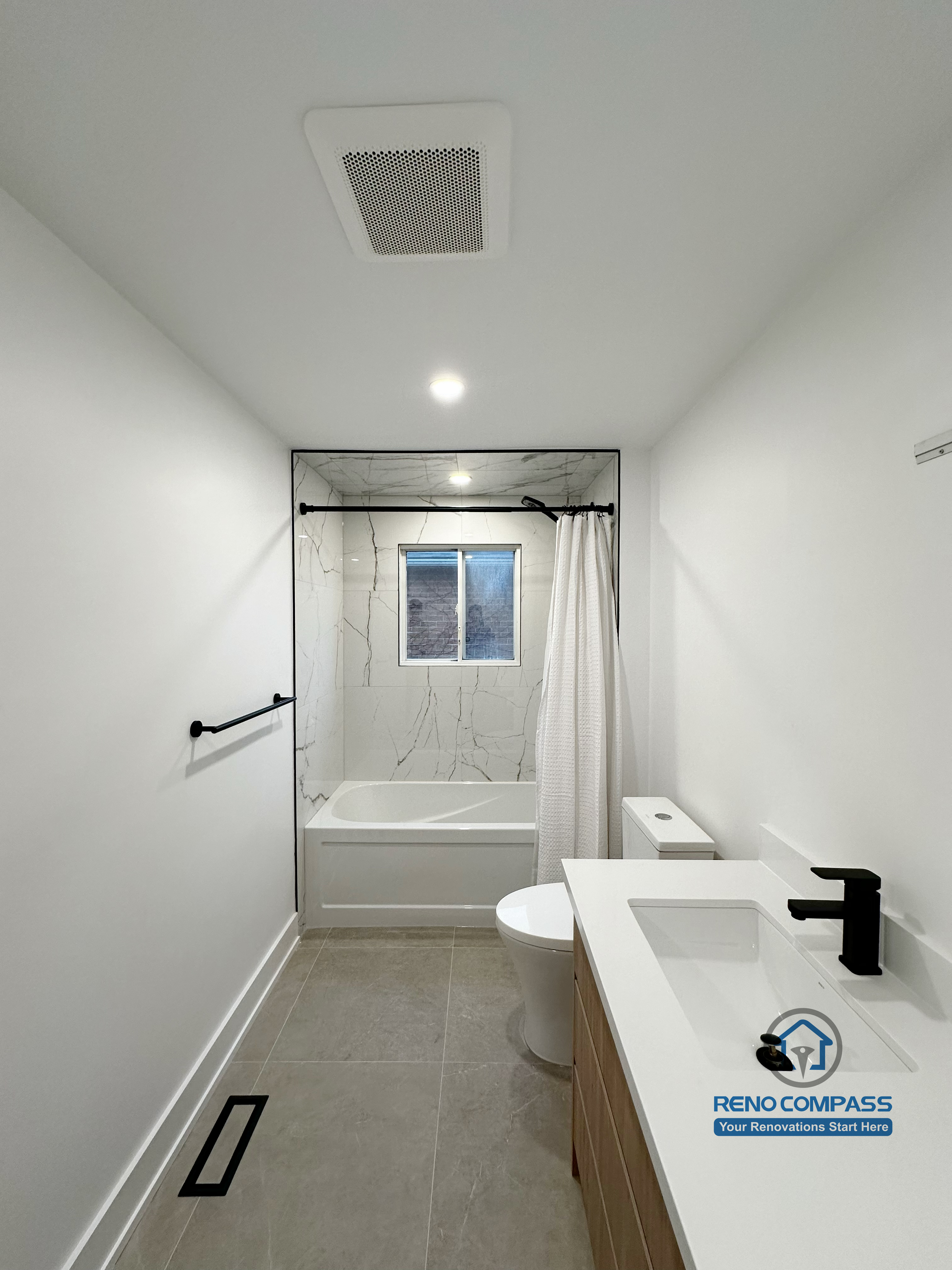 Oakville bathroom renovation featuring a clean secondary bathroom layout with bathtub, modern vanity, matte black fixtures, and efficient space planning, completed by a professional Toronto renovation company.
