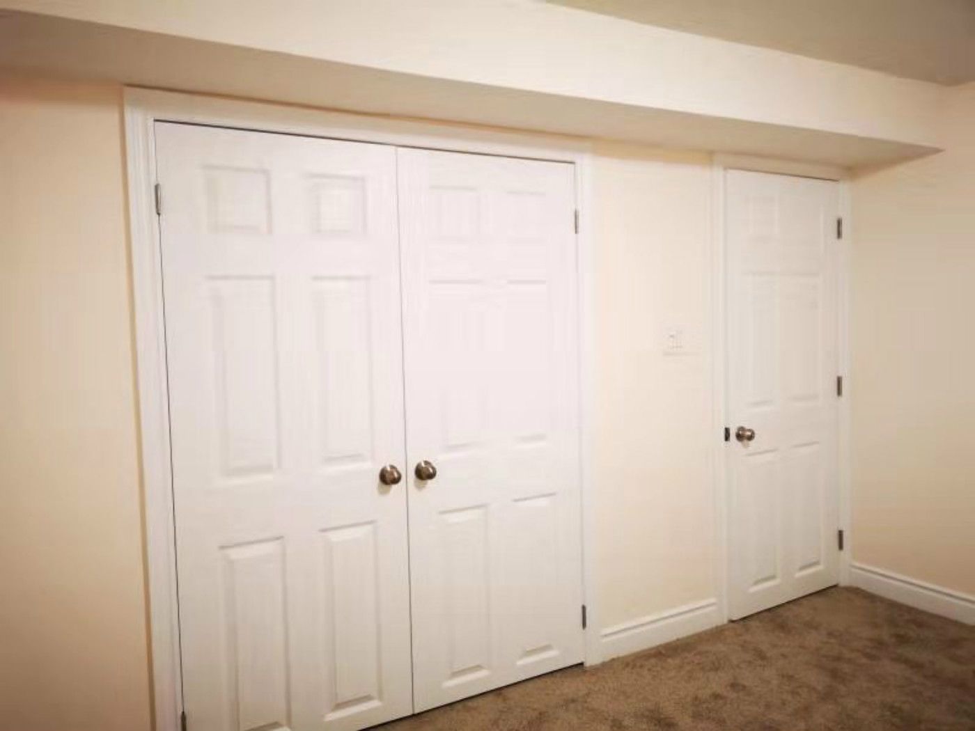 This Mississauga basement features standard double-door storage closets and interior doors with a basic finish. The space highlights opportunities for upgraded doors, improved trim work, and enhanced storage design. A professional Toronto renovation company can elevate both functionality and aesthetics with modern finishes and better space utilization.