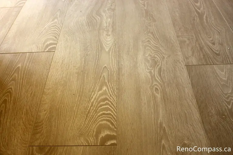 High-quality wide-plank wood-look flooring and custom baseboard installation for an interior renovation in Oshawa, Ontario. Professional craftsmanship by RenoCompass.ca to enhance home value and modern aesthetics.