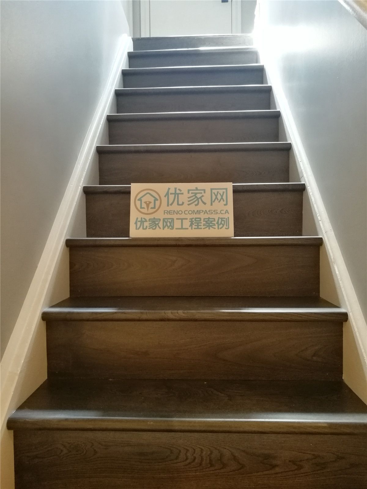 This image features a completed staircase as part of a Toronto basement renovation, showcasing hardwood stair treads with clean, modern finishes. The staircase connects the basement to the main level, providing a seamless visual transition that matches the updated flooring and neutral wall colors. Precise installation and durable materials ensure both safety and long-term performance. This staircase upgrade reflects the craftsmanship and attention to detail offered by a professional Toronto renovation company.