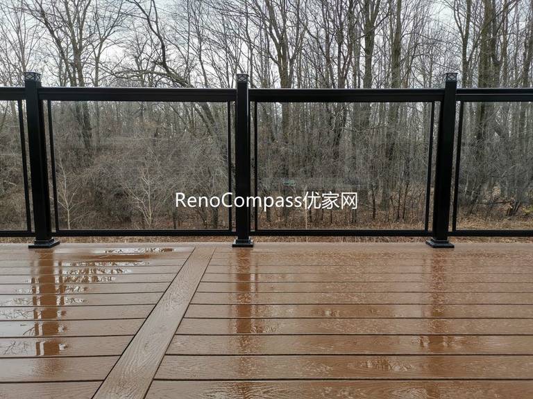 Aurora backyard deck renovation featuring premium composite decking, sleek black aluminum and glass railings, and professional outdoor construction. Designed for durability and low maintenance, this modern deck provides a safe, stylish, and functional outdoor living space while enhancing overall property value.