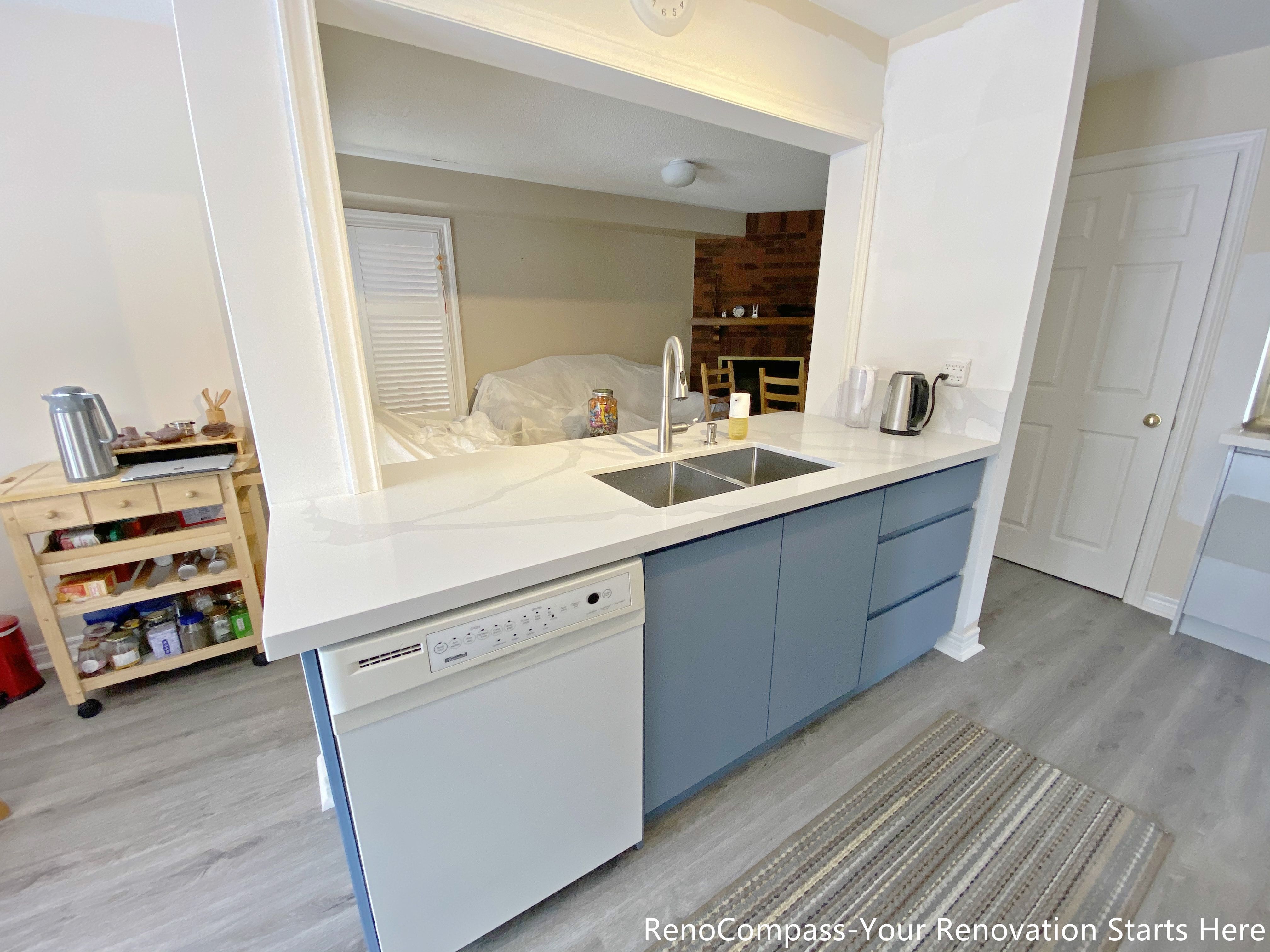 This image features a functional kitchen island completed as part of a Mississauga kitchen renovation. The island is topped with a durable quartz countertop and includes an undermount sink, modern faucet, and an integrated dishwasher for efficient cleanup. Base cabinetry provides concealed storage while maintaining a clean and streamlined appearance. Positioned to connect the kitchen with the surrounding living space, this island design supports everyday meal preparation, cleaning, and casual use in modern Mississauga homes.