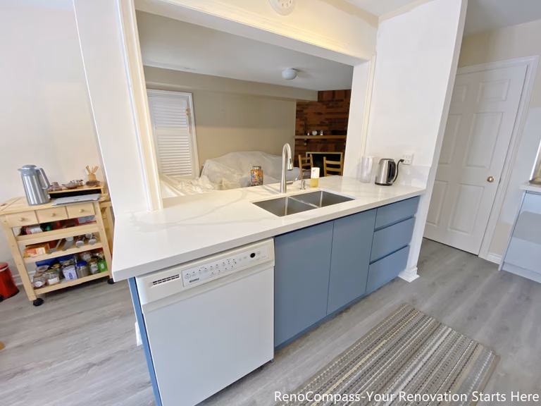 This image features a functional kitchen island completed as part of a Mississauga kitchen renovation. The island is topped with a durable quartz countertop and includes an undermount sink, modern faucet, and an integrated dishwasher for efficient cleanup. Base cabinetry provides concealed storage while maintaining a clean and streamlined appearance. Positioned to connect the kitchen with the surrounding living space, this island design supports everyday meal preparation, cleaning, and casual use in modern Mississauga homes.
