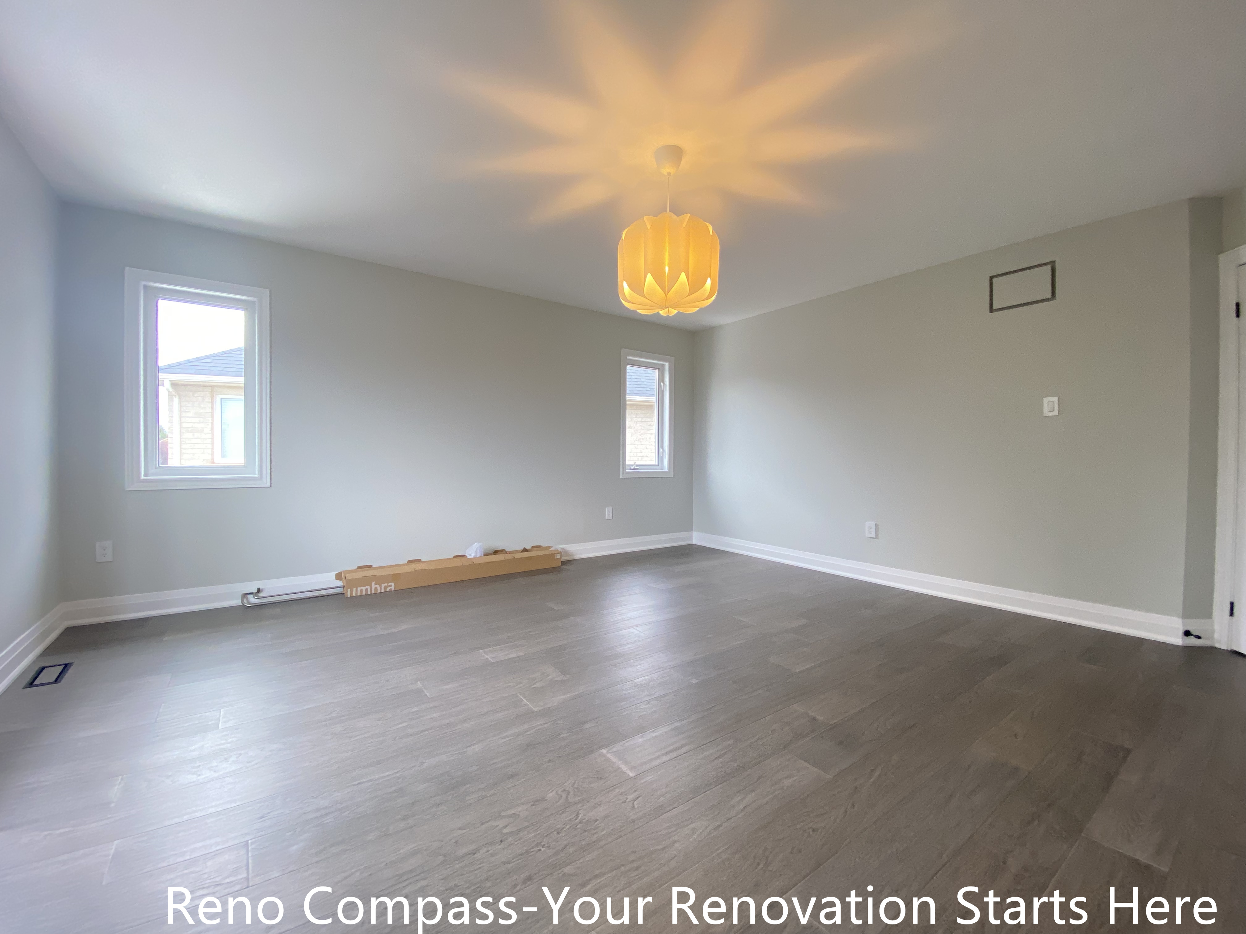 Open concept interior space featured in an Oakville interior renovation, showcasing modern flooring, soft neutral wall tones, and decorative ceiling lighting. The bright and flexible layout allows for use as a bedroom, family room, or multipurpose space, completed by a professional Toronto renovation company.
