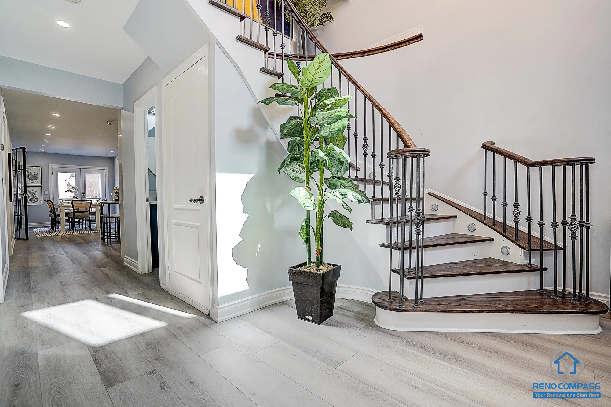 Located in Vaughan Maple, this project includes a staircase renovation with dark wood treads and black iron railings. Combined with new flooring, pot lights, and wall painting, the space feels open, clean, and elevated. A high-quality Toronto interior renovation project.
