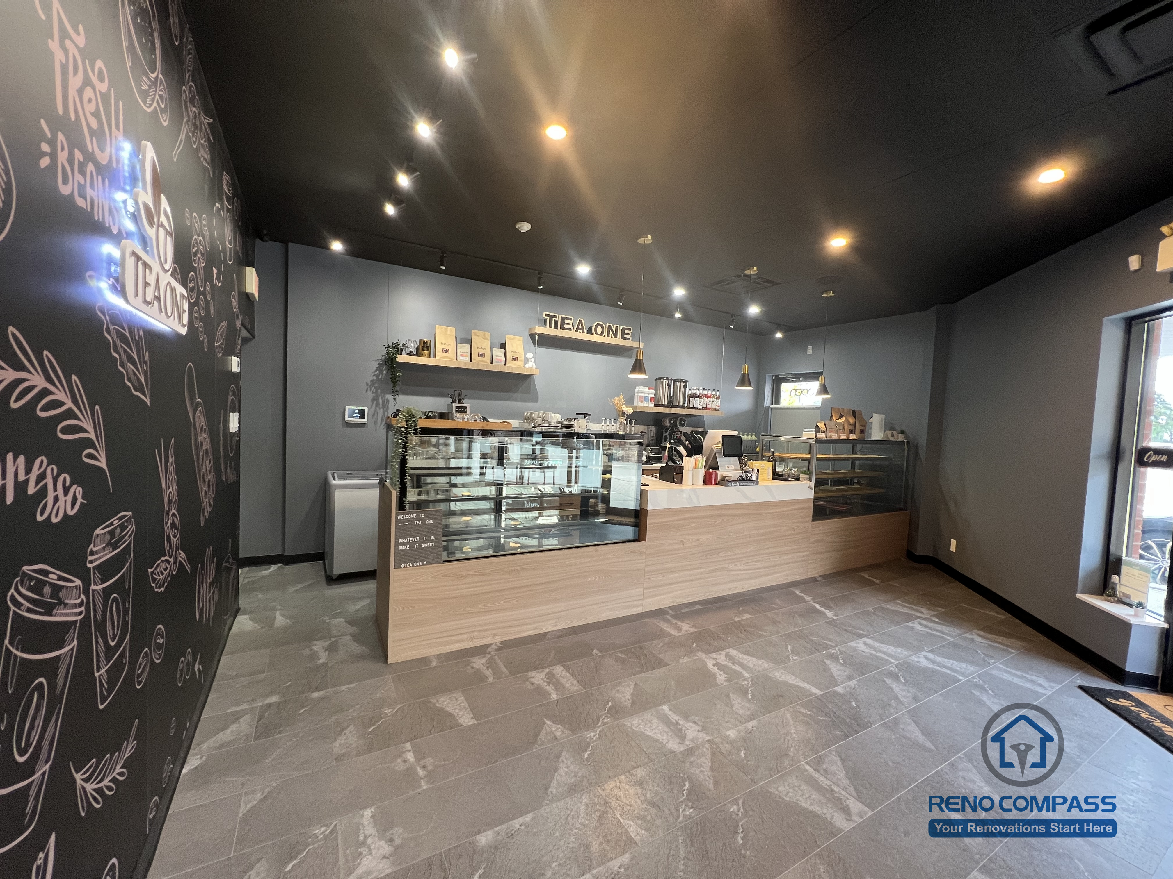 This Mississauga restaurant renovation features a modern front counter and service area with custom millwork, integrated display cases, and ambient lighting. The layout is designed to improve customer flow, enhance ordering efficiency, and create a welcoming commercial dining environment.