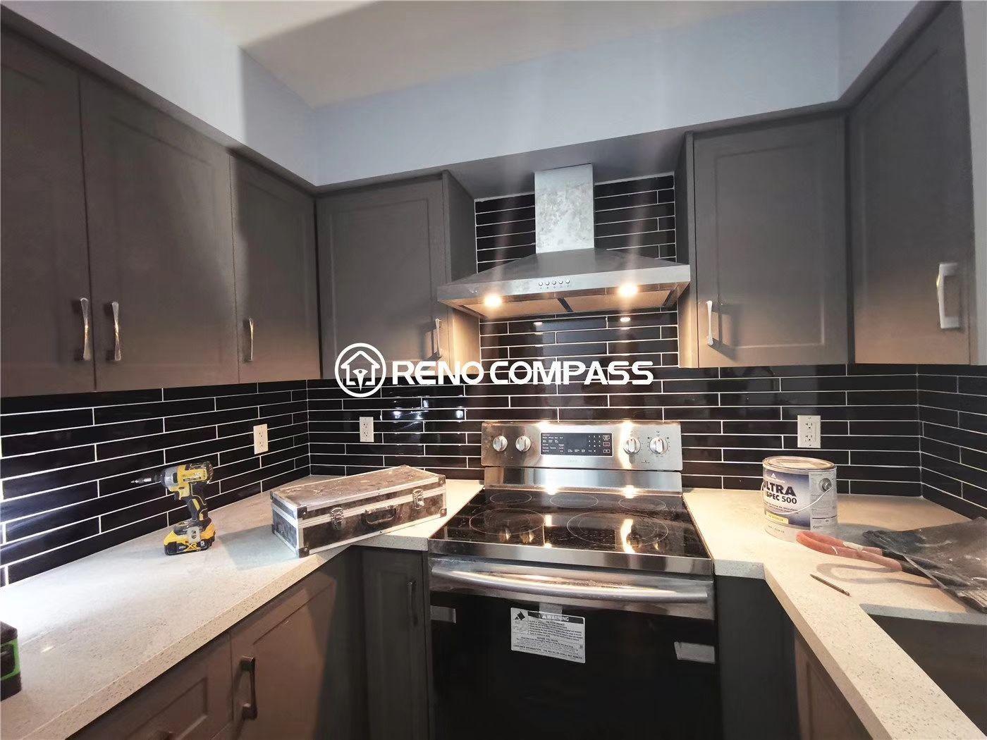 This Richmond Hill condo kitchen renovation showcases newly installed modern grey cabinets, a durable quartz countertop, and a sleek black subway tile backsplash. The project highlights precise cabinetry installation, upgraded lighting, and stainless steel appliance integration to enhance both functionality and visual appeal. Completed by a professional Toronto renovation team, this condo upgrade delivers a clean, modern kitchen design ideal for everyday living.