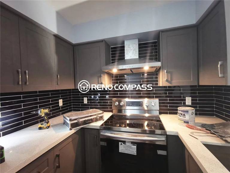 This Richmond Hill condo kitchen renovation showcases newly installed modern grey cabinets, a durable quartz countertop, and a sleek black subway tile backsplash. The project highlights precise cabinetry installation, upgraded lighting, and stainless steel appliance integration to enhance both functionality and visual appeal. Completed by a professional Toronto renovation team, this condo upgrade delivers a clean, modern kitchen design ideal for everyday living.