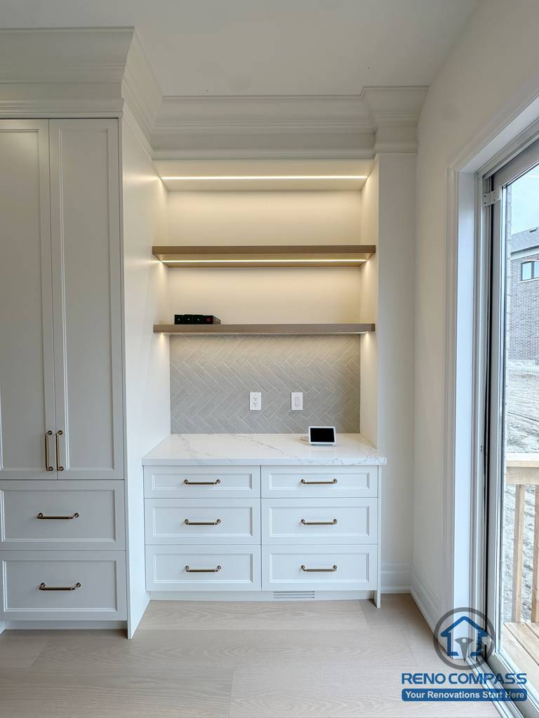 Custom built-in cabinet with drawers and floating shelves, featuring integrated lighting for improved storage and clean design in a Toronto home renovation.