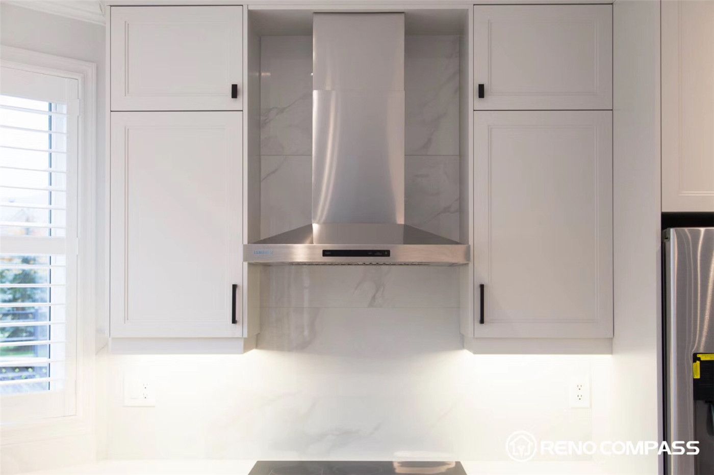 This Markham kitchen renovation highlights custom white shaker cabinets paired with a sleek stainless steel range hood and marble-look backsplash. The clean lines, modern finishes, and built-in cabinetry create a bright, functional, and elegant cooking space designed for both style and everyday use.