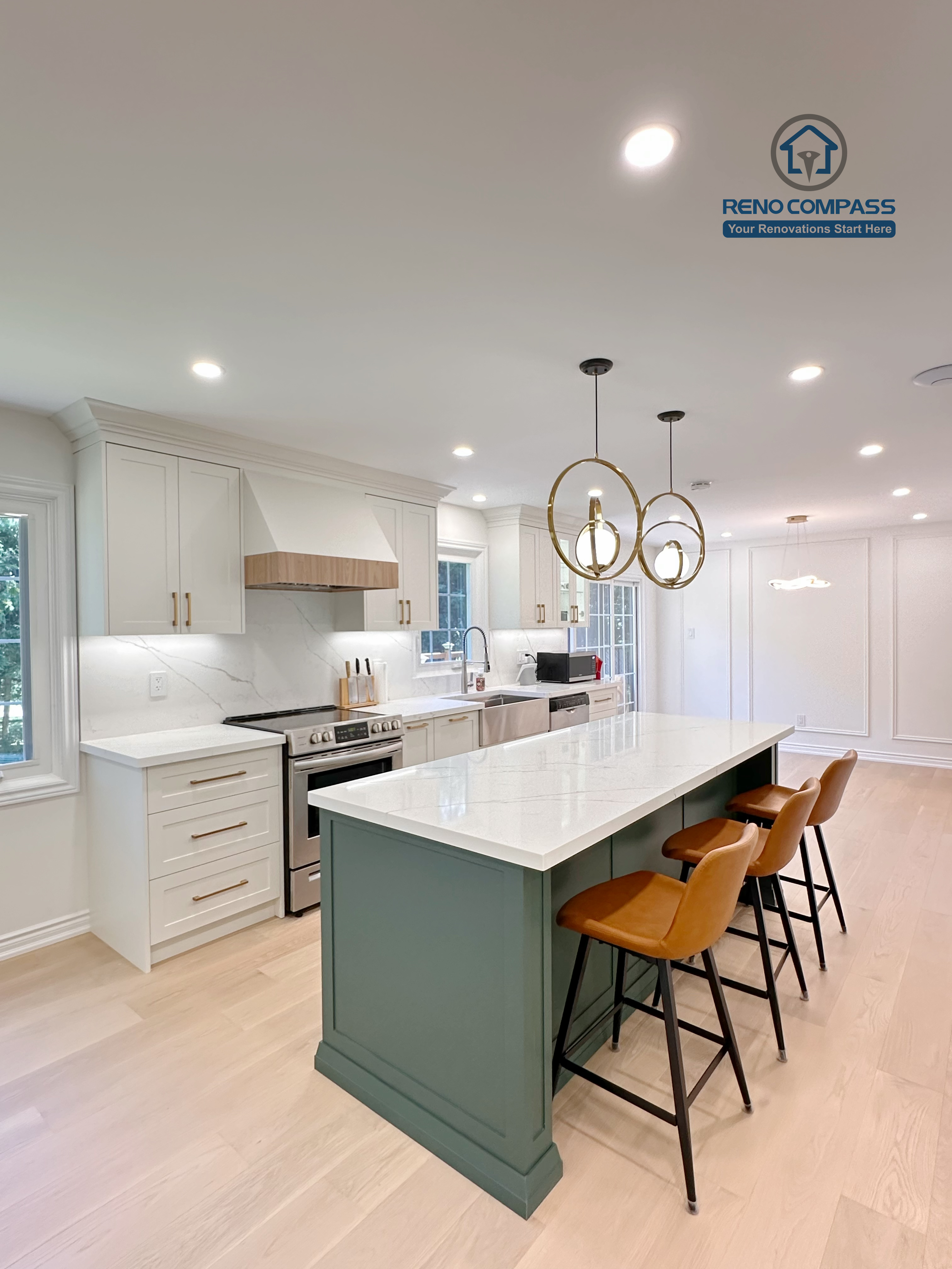 This Markham kitchen renovation features an open-concept layout centered around a custom green island with quartz countertops and seating. White cabinetry, brass hardware, and stainless steel appliances create a clean and cohesive design, while recessed lighting and wide-plank hardwood flooring enhance brightness and flow. Completed by a professional Toronto renovation company, Reno Compass Inc., the kitchen is designed for everyday functionality and long-term comfort.