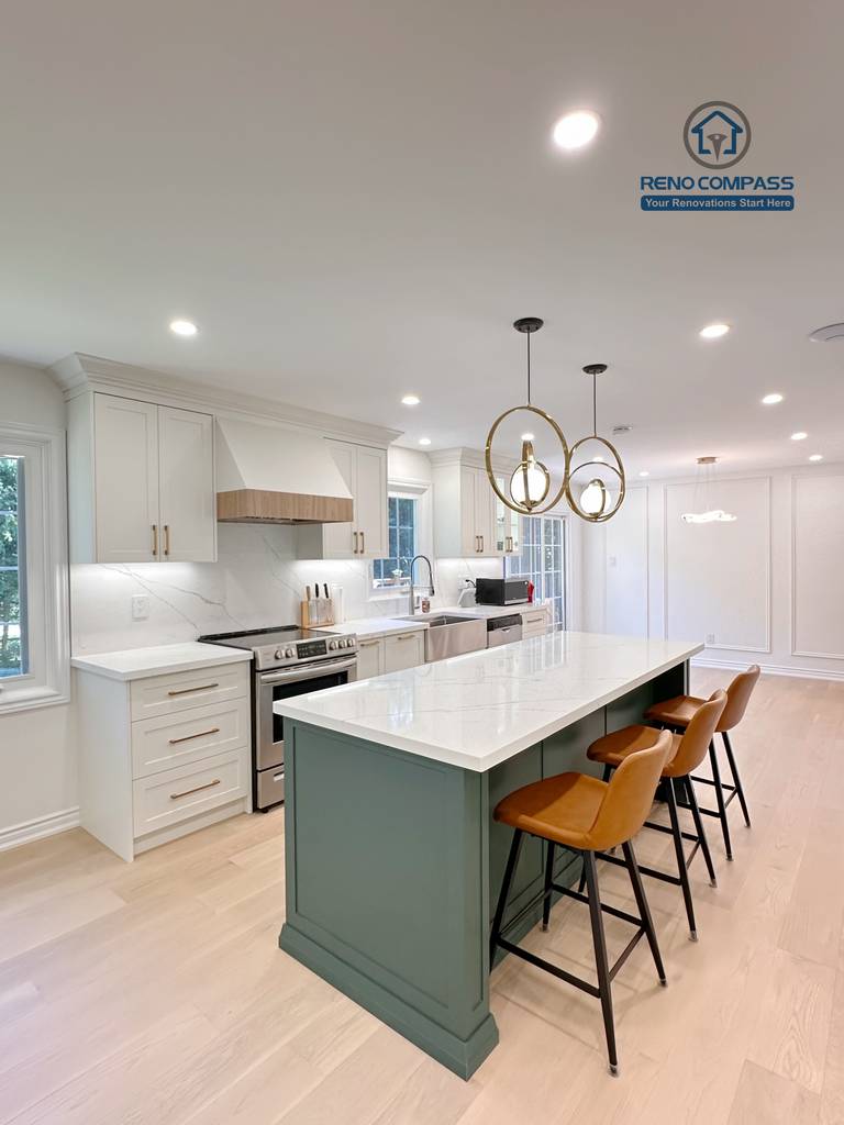 This Markham kitchen renovation features an open-concept layout centered around a custom green island with quartz countertops and seating. White cabinetry, brass hardware, and stainless steel appliances create a clean and cohesive design, while recessed lighting and wide-plank hardwood flooring enhance brightness and flow. Completed by a professional Toronto renovation company, Reno Compass Inc., the kitchen is designed for everyday functionality and long-term comfort.