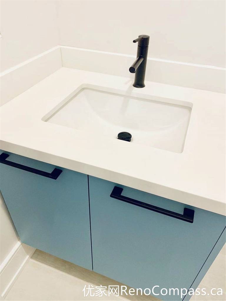 A close-up view of the custom bathroom vanity from this Markham renovation showcases a seamless integrated sink, soft blue cabinetry, and a matte black faucet. The clean lines and durable materials reflect a modern design approach focused on both functionality and long-term performance.