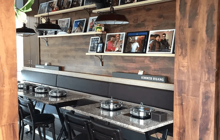 Modern restaurant interior renovation in Markham featuring custom wall shelving, warm wood finishes, pendant lighting, and functional dining seating layout. Designed to enhance customer comfort, brand presentation, and dining experience in a commercial restaurant space. Completed by a trusted Toronto renovation company, Reno Compass Inc., specializing in restaurant and commercial renovation projects across the GTA.