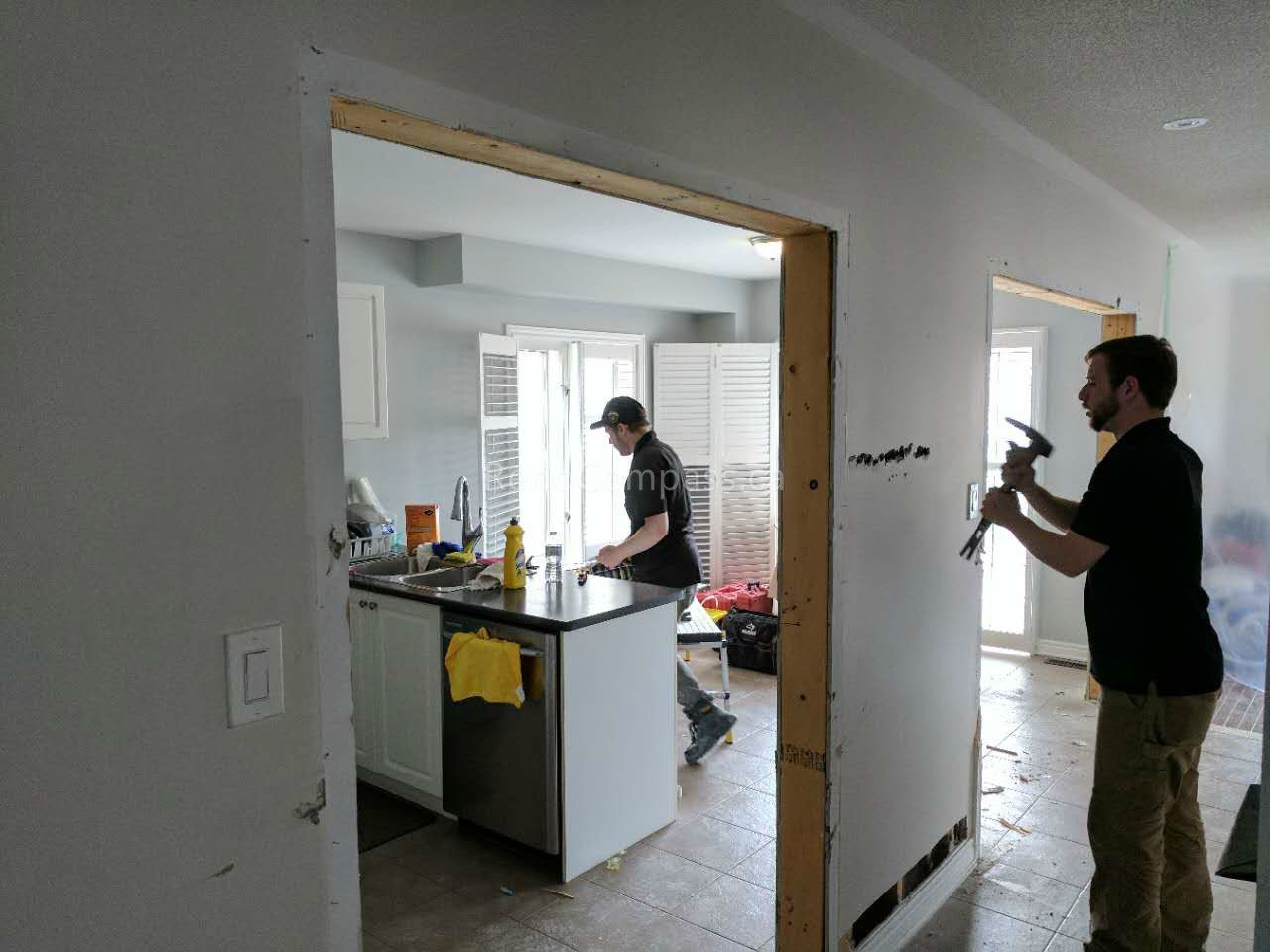 This Vaughan kitchen renovation showcases the remodeling process during construction, including structural opening expansion and layout reconfiguration to create a more open-concept kitchen. Reno Compass Inc. redesigned the space to improve flow, lighting, and functionality, preparing for new cabinetry, countertops, and modern finishes. Professional demolition and framing work ensure a strong foundation for a stylish and efficient kitchen transformation.