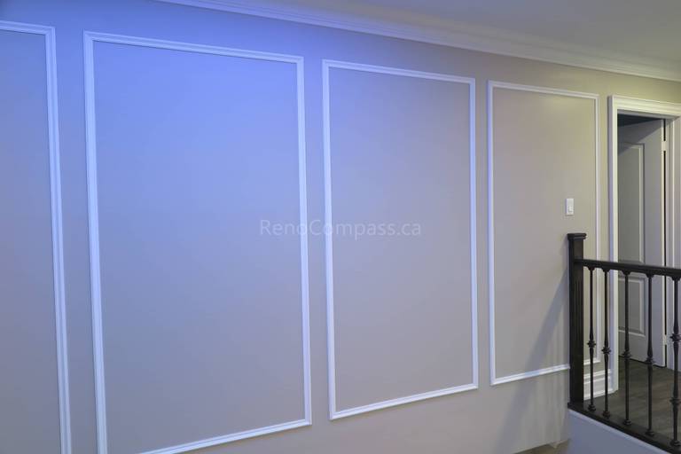 This Markham interior renovation features elegant custom wall panel molding that enhances the home's architectural detail and modern aesthetic. Clean trim lines, neutral wall tones, and quality finishing create a refined and sophisticated interior space that complements the staircase and upper hallway area. Completed by Reno Compass, a professional renovation contractor specializing in custom interior finishing and full home renovations across Markham and the Greater Toronto Area.