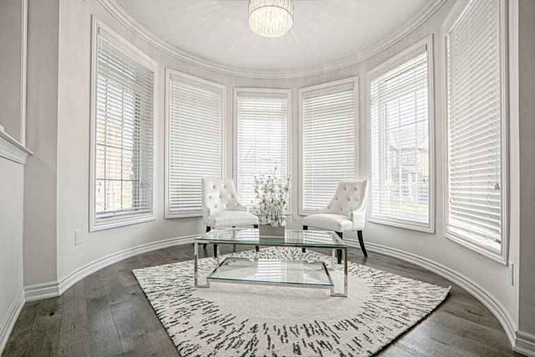 This Toronto luxury sitting area renovation features a bright curved bay window design that fills the space with natural light and enhances the open, elegant atmosphere. The interior showcases premium hardwood flooring, modern classic furnishings, and refined ceiling lighting that create a sophisticated lounge area for relaxation. Completed by a professional Toronto renovation company, this project highlights functional luxury, timeless design, and high-end residential interior craftsmanship tailored for contemporary living.
