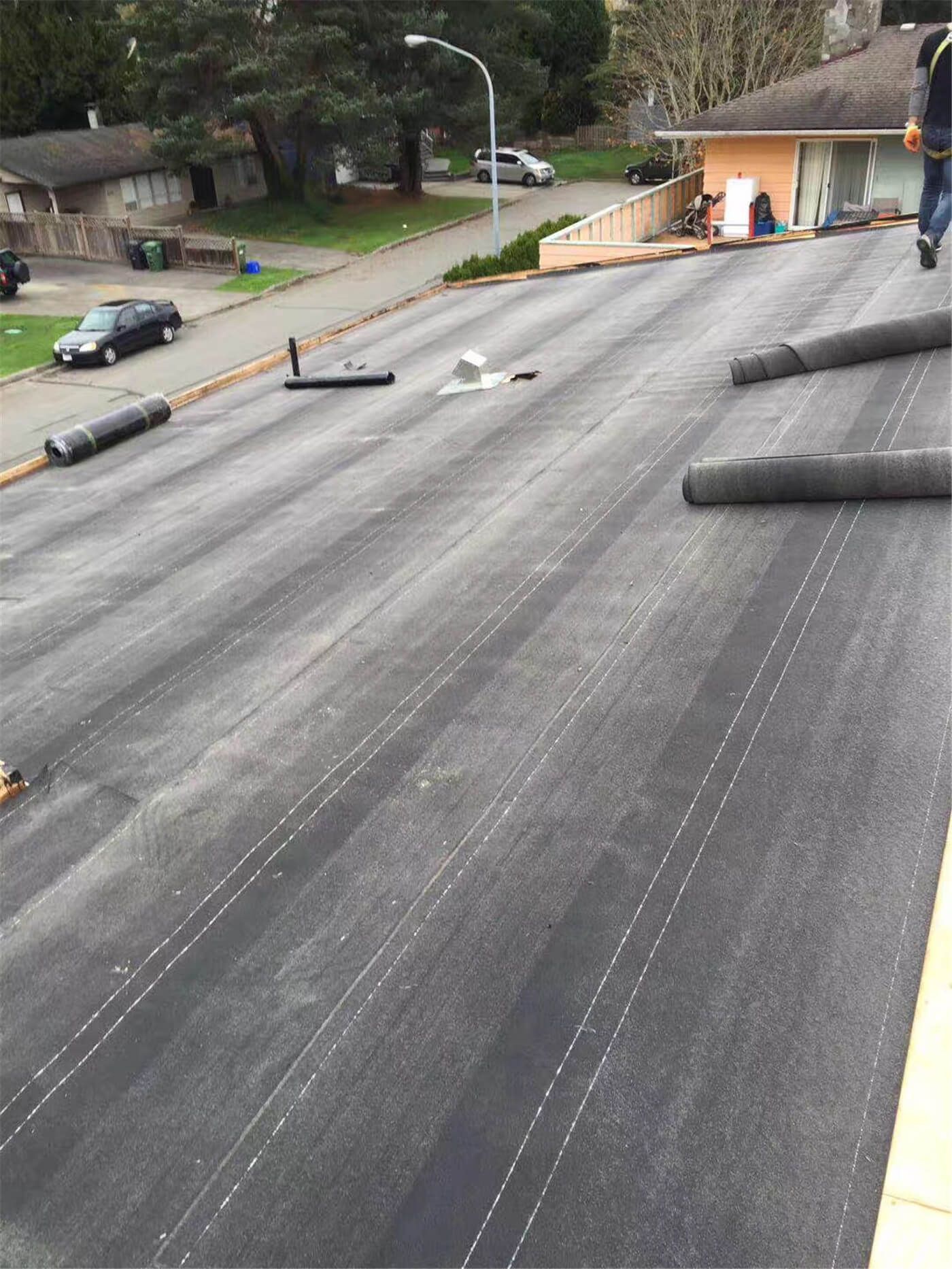 New asphalt shingle roof installation in Toronto, showing precise shingle alignment, proper underlayment coverage, and clean roof edge detailing. The roofing system includes upgraded flashing and vent pipe installation to ensure effective water drainage, ventilation, and long-term weather resistance. This roof replacement improves both durability and curb appeal while meeting Toronto building code standards.