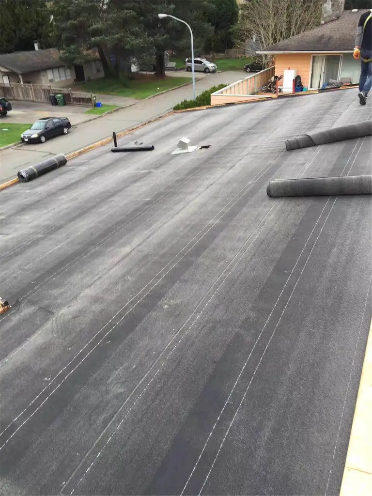New asphalt shingle roof installation in Toronto, showing precise shingle alignment, proper underlayment coverage, and clean roof edge detailing. The roofing system includes upgraded flashing and vent pipe installation to ensure effective water drainage, ventilation, and long-term weather resistance. This roof replacement improves both durability and curb appeal while meeting Toronto building code standards.